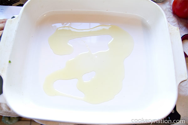 Grease a baking dish large enough to fit the tomatoes using 1 Tablespoon of the Olive Oil.