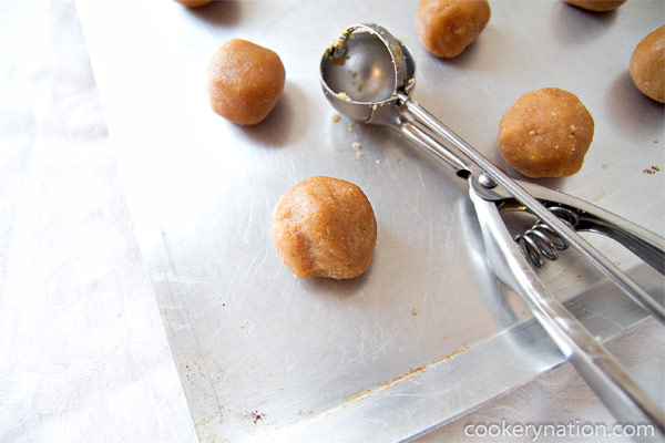 Use a small scoop or teaspoon to scoop out cookie dough and use your hands to roll into balls. Place on ungreased cookie sheet