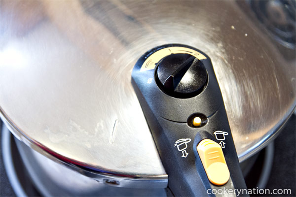Secure pressure cooker lid and bring up to pressure over high heat.