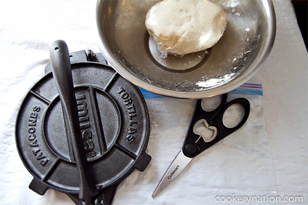 While the dough is resting, cut out the plastic covering for your press. If you do not have a tortilla press, you can use a rolling pin. It is easiest to roll in between two pieces of plastic.